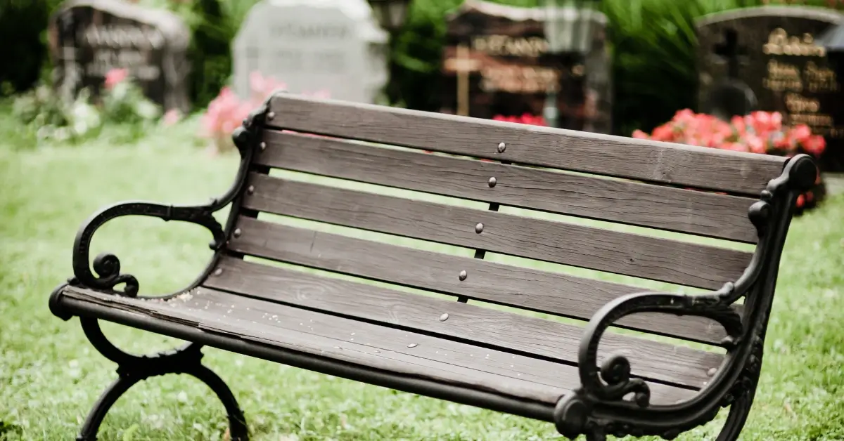 a garden bench in a cemetery